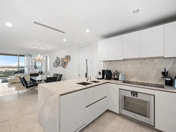 a kitchen with a sink stove and cabinets