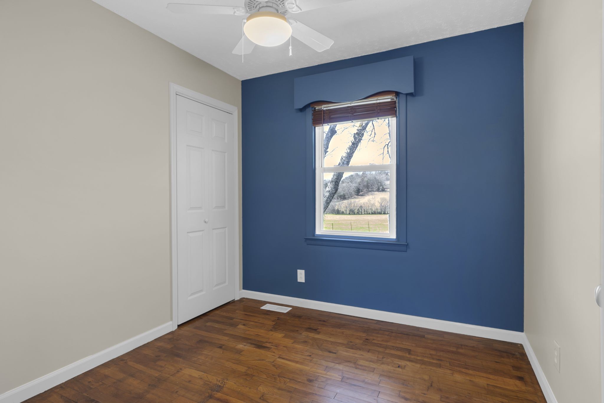 2084 Center Point Road Pulaski, TN 38478 - Photo 11 of 31 an empty room with wooden floor and windows