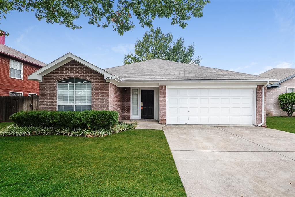 a front view of a house with a garden and plants