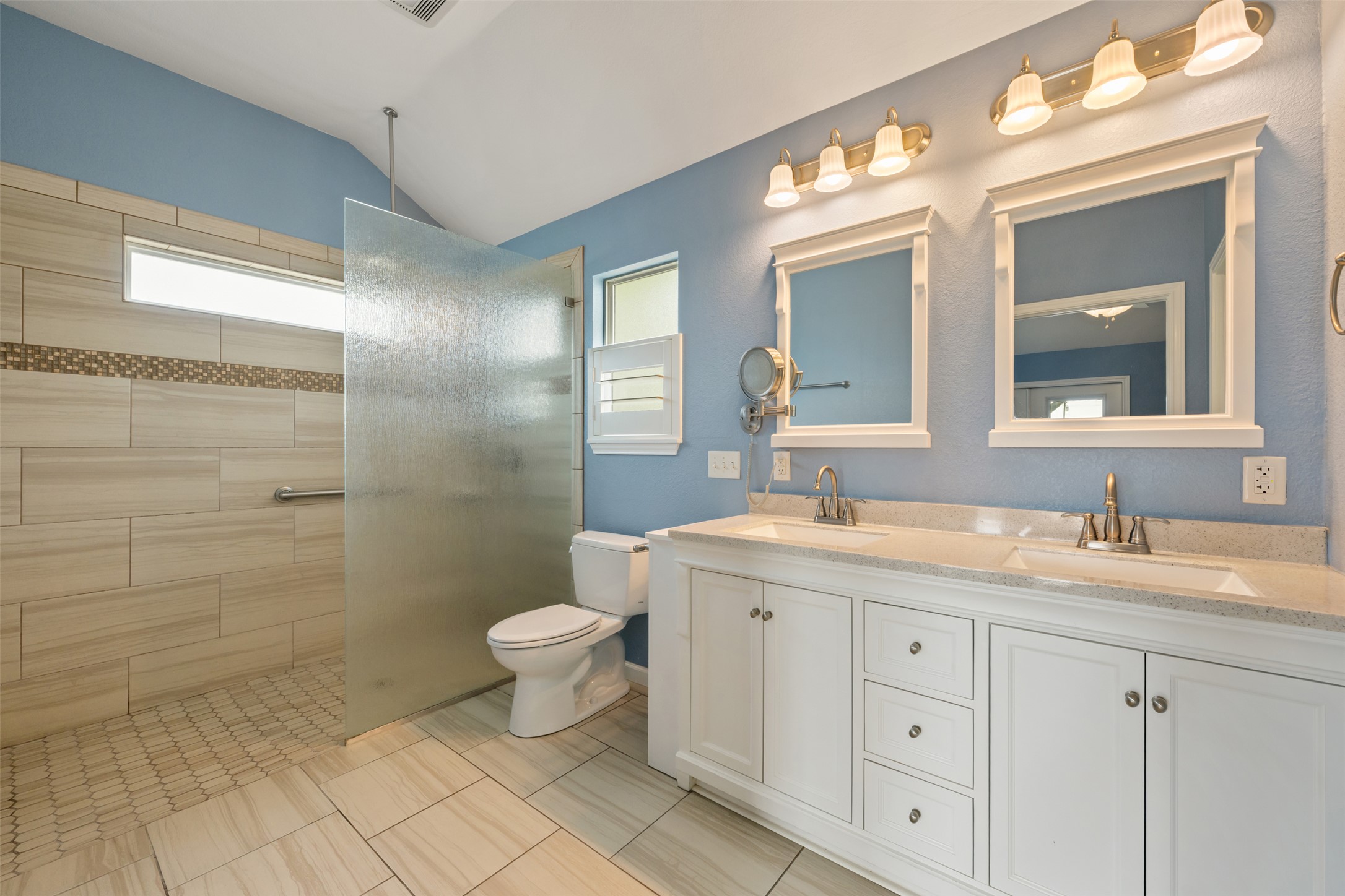 104 Sunset Road Georgetown, TX 78633 - Photo 22 of 40 Full bath featuring double vanity, plenty of natural light, a walk in shower, and vaulted ceiling