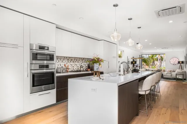 a kitchen with a sink stainless steel appliances and cabinets
