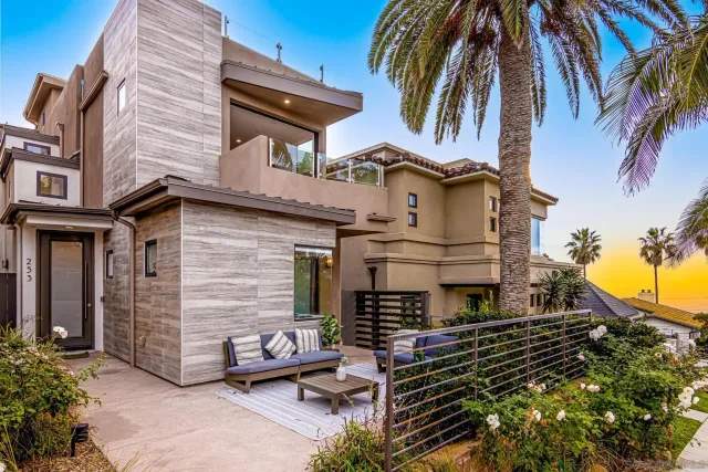 a front view of a house with a garden