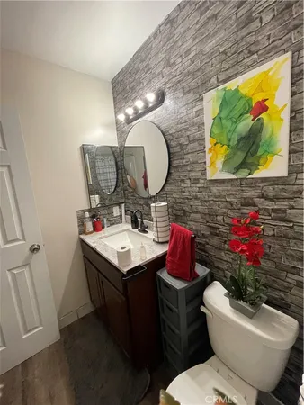 a bathroom with a sink mirror and toilet