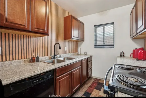 a kitchen with a sink stove and cabinets