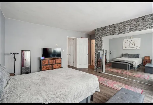 a bedroom with a bed and a flat screen tv