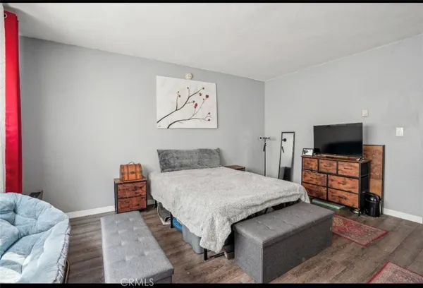 a bedroom with a bed and flat screen tv