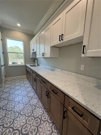 a kitchen with stainless steel appliances granite countertop a sink a stove and a microwave