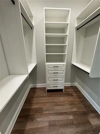 a view of walk in closet with empty racks