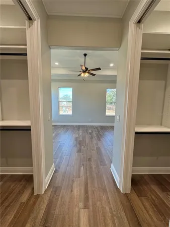 a view of a hallway with wooden floor