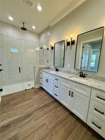 a spacious bathroom with double sink and a large mirror