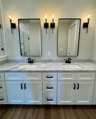 a bathroom with double vanity sink and mirror