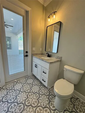 a bathroom with a toilet sink and mirror