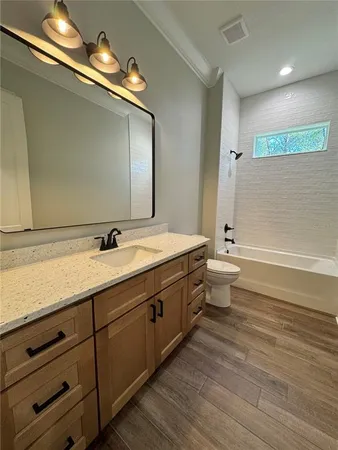 a bathroom with a double vanity sink and a toilet