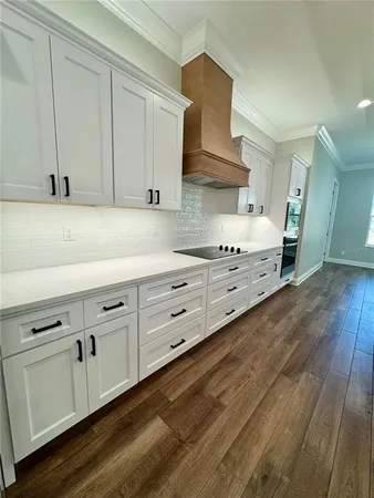 a kitchen with granite countertop white cabinets and white appliances