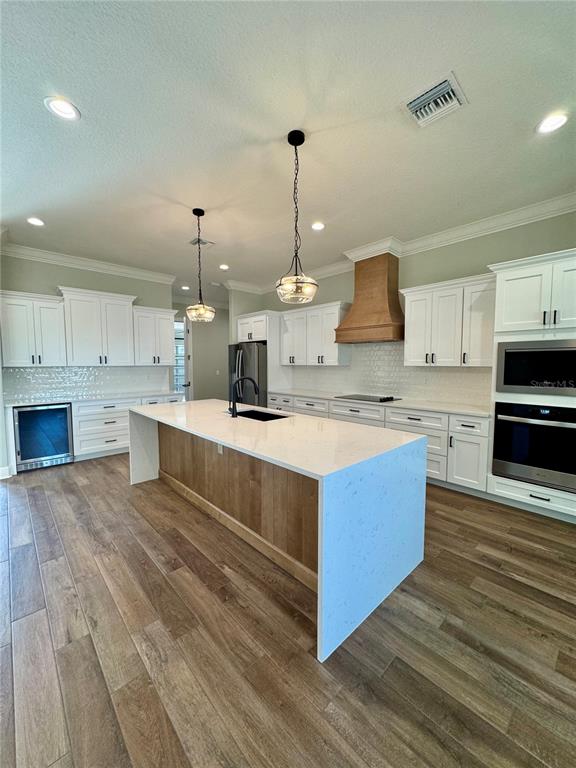 18354 Southwest 65th Loop Dunnellon, FL 34432 - Photo 10 of 35 a large kitchen with stainless steel appliances kitchen island granite countertop a stove a sink dishwasher and a white countertops with wooden floor