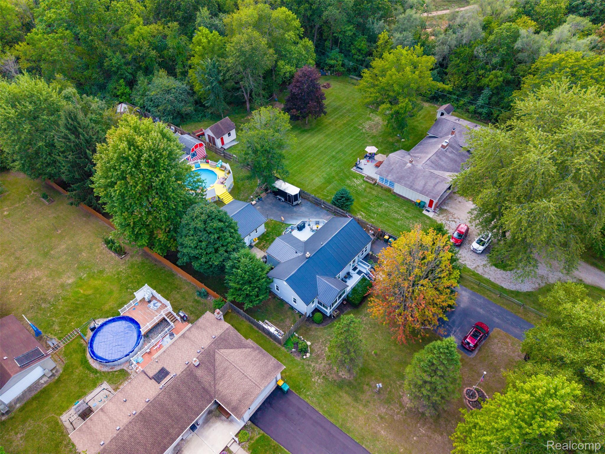 36739 Wick Road Romulus, MI 48174 - Photo 43 of 56 Two separate residential structures, mature trees, an above-ground pool, and a gravel driveway