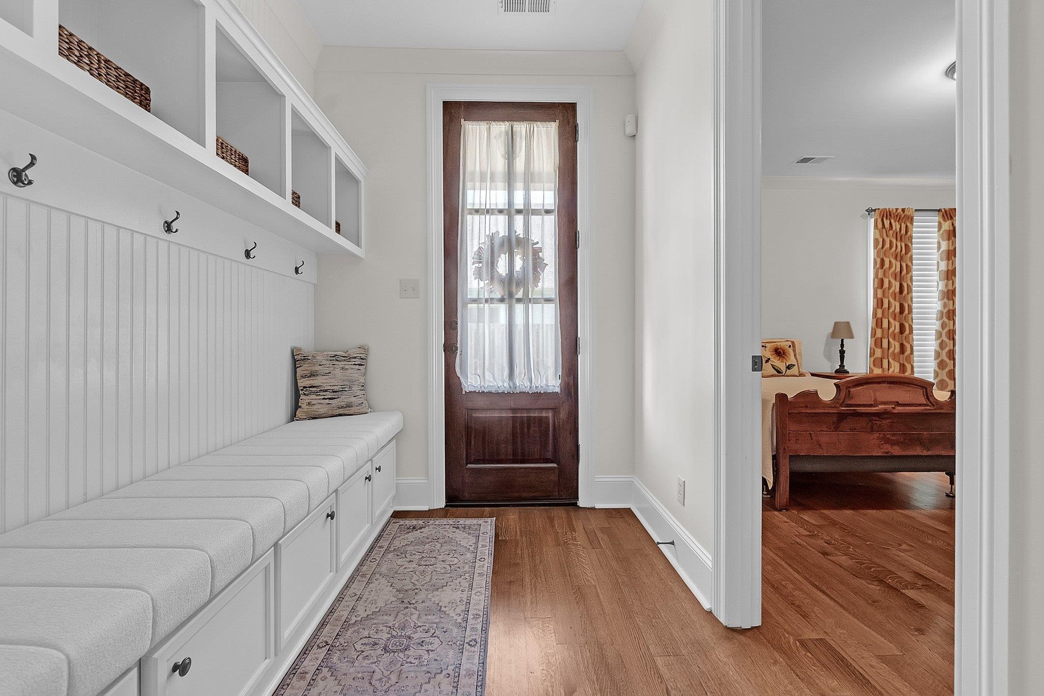 3246 North Hartwell Ridge Drive Collierville, TN 38017 - Photo 12 of 40 Entry mudroom featuring built-in white cabinetry with beadboard backing, an integrated bench with cushioned seating, and multiple storage compartments