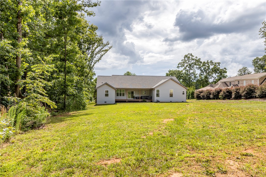3080 McGee Road Iva, SC 29655 - Photo 41 of 49 A spacious backyard with mature trees, offering a private setting for outdoor living.