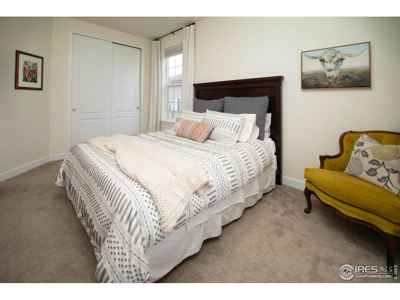 7086 Thunderview Drive Timnath, CO 80547 - Photo 25 of 38 a bedroom with a bed and couch