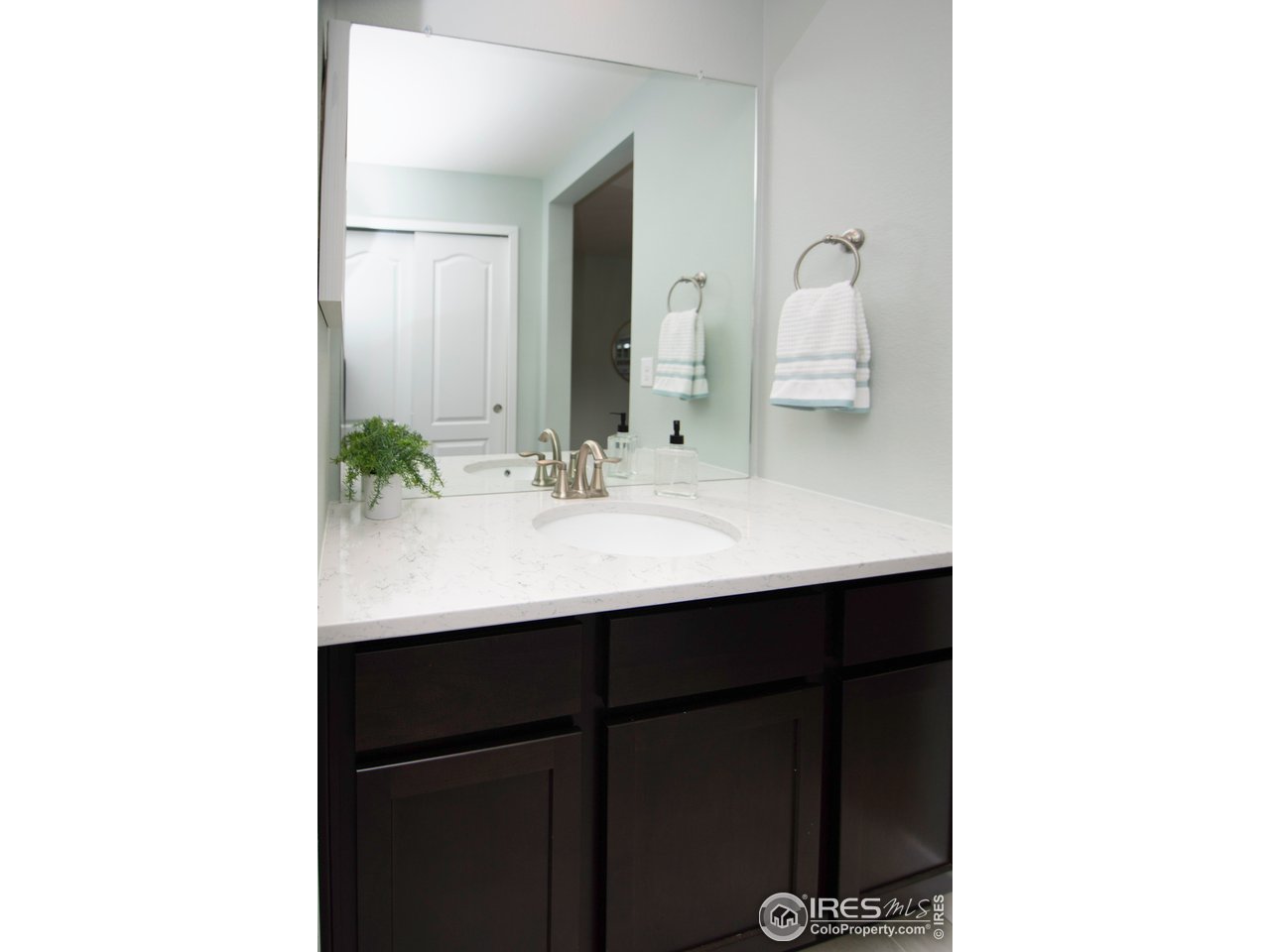 7086 Thunderview Drive Timnath, CO 80547 - Photo 27 of 38 a bathroom with a sink and a mirror