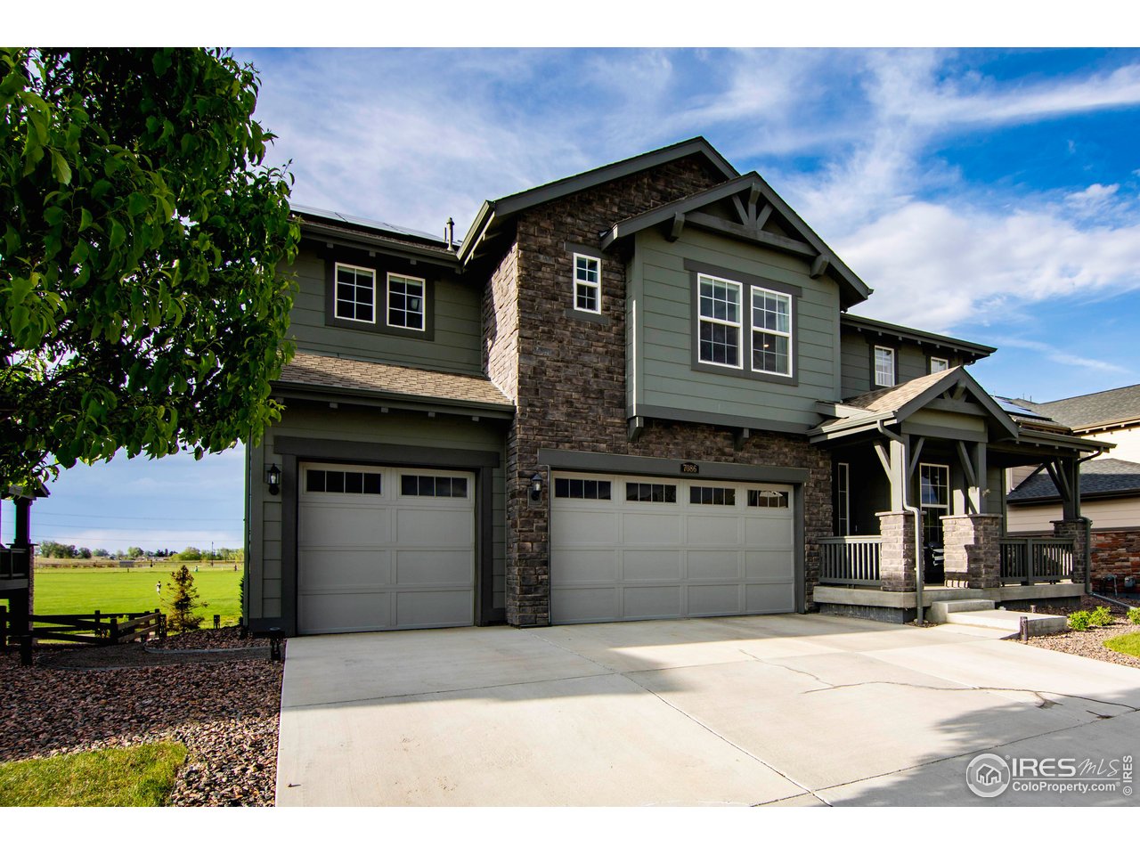 7086 Thunderview Drive Timnath, CO 80547 - Photo 3 of 38 a front view of a house with a garden