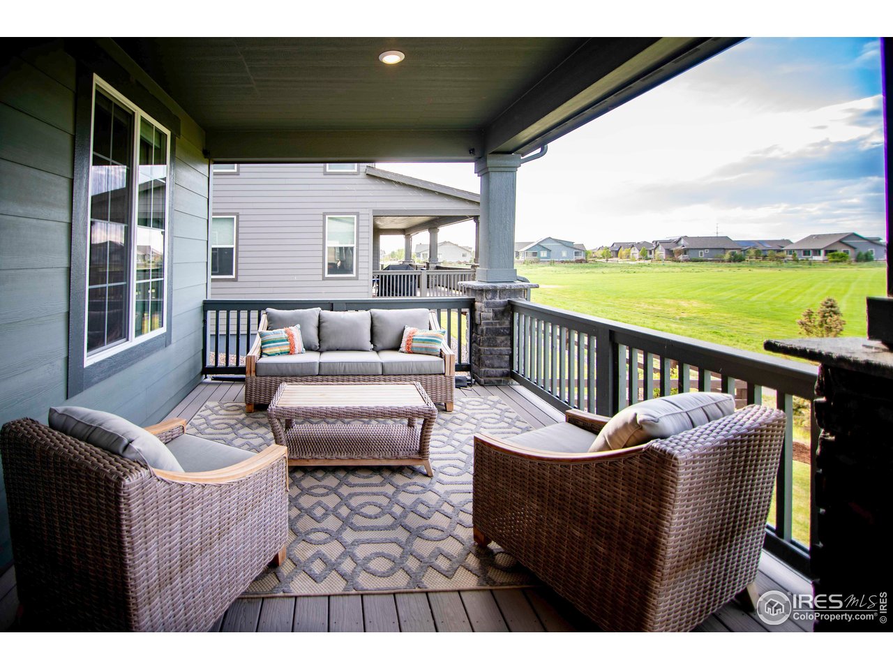 7086 Thunderview Drive Timnath, CO 80547 - Photo 9 of 38 a balcony with furniture and a garden