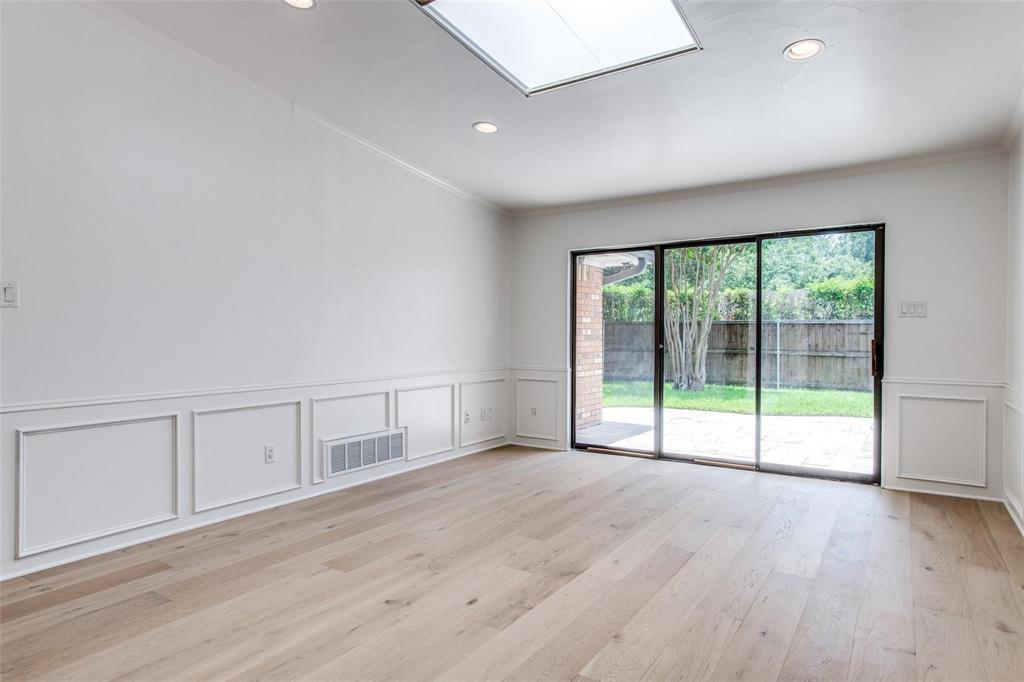 6926 Northwood Road Dallas, TX 75225 - Photo 18 of 29 a view of an empty room with wooden floor and a window