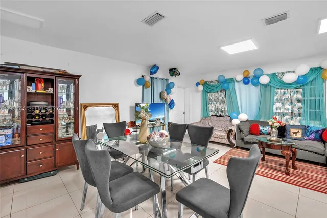a living room with furniture a rug and a flat screen tv