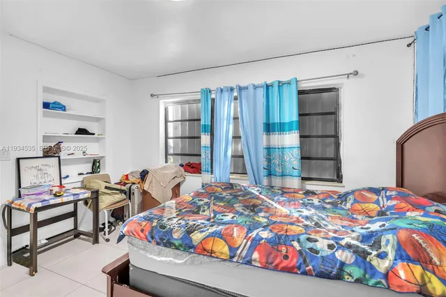 a bedroom with bed and a window