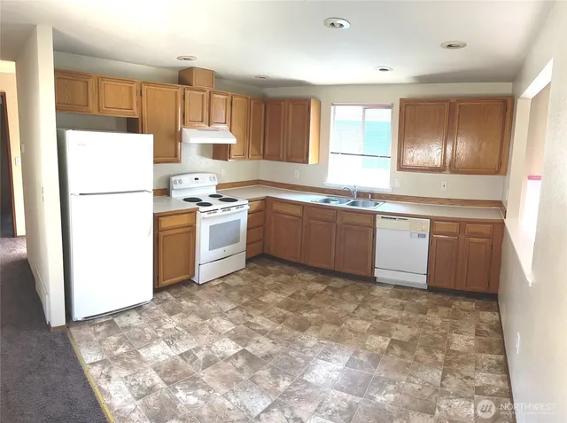 a kitchen with sink cabinets and refrigerator