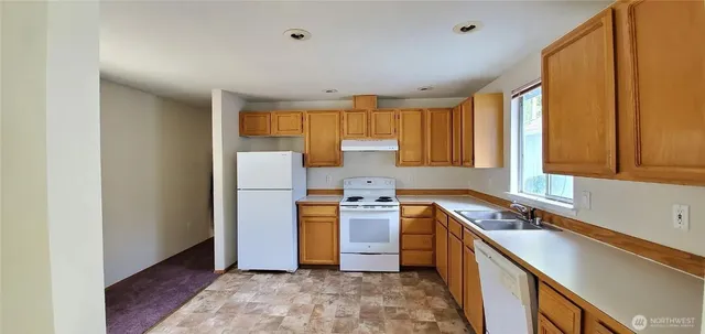 a kitchen with a stove a sink and a refrigerator