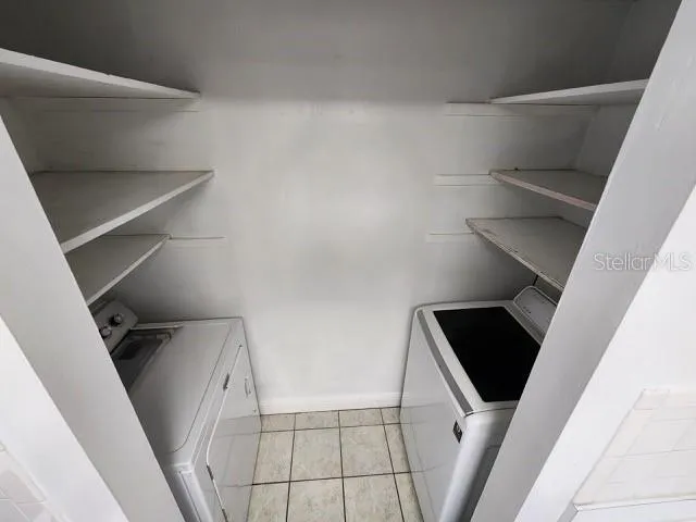 an aerial view of a house with a garden and large trees