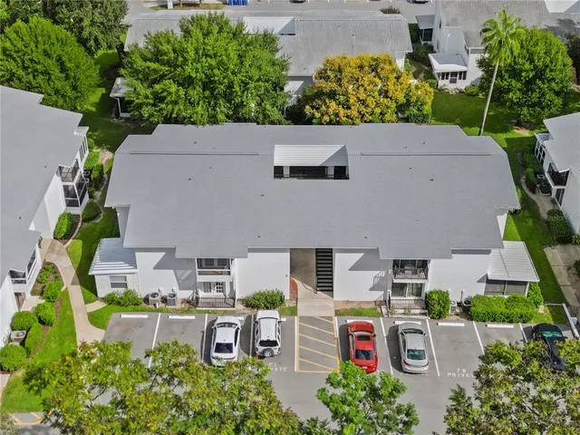 an aerial view of a house with a yard and a large pool