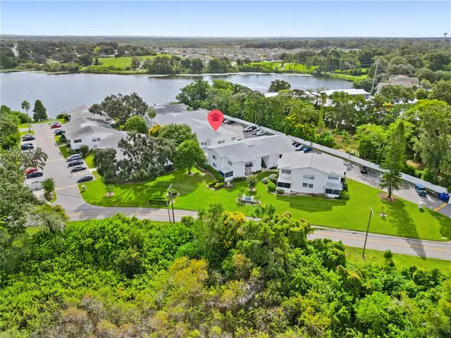 an aerial view of a houses with a yard