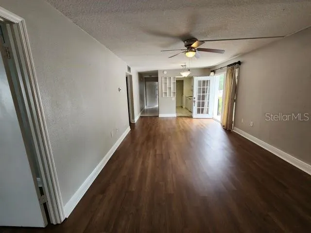 a view of empty room with wooden floor