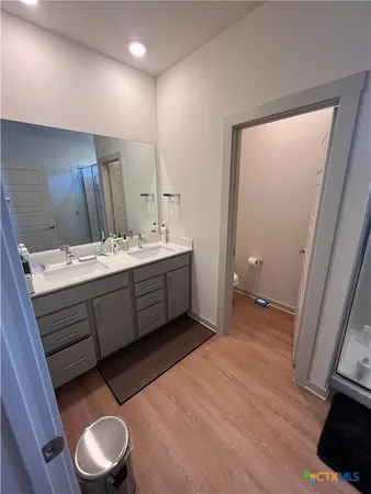 a room with a sink mirror and toilet