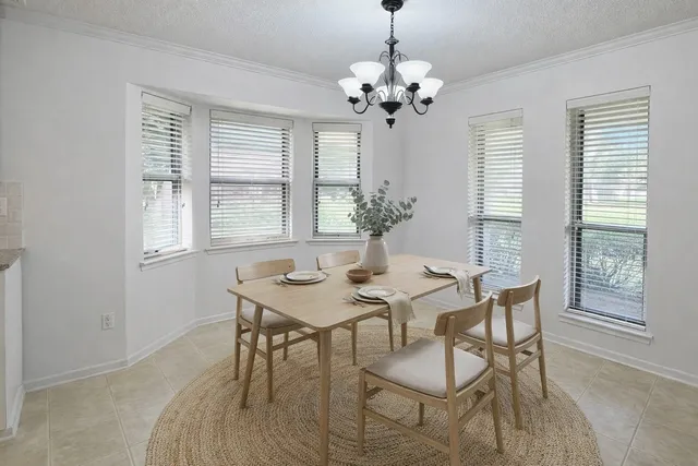 a kitchen with granite countertop a sink stainless steel appliances white cabinets and a window
