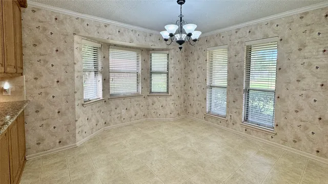 a view of a livingroom with a chandelier a kitchen sink and dishwasher