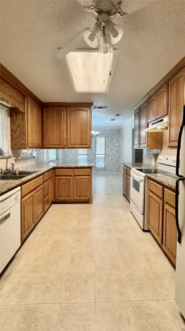 a large kitchen with cabinets and wooden floor