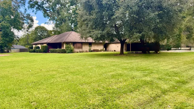 a house with a yard and large trees