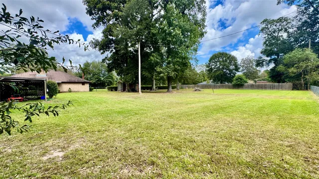 a view of outdoor space with garden and trees