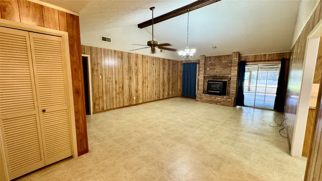 a view of a livingroom with a fireplace and window
