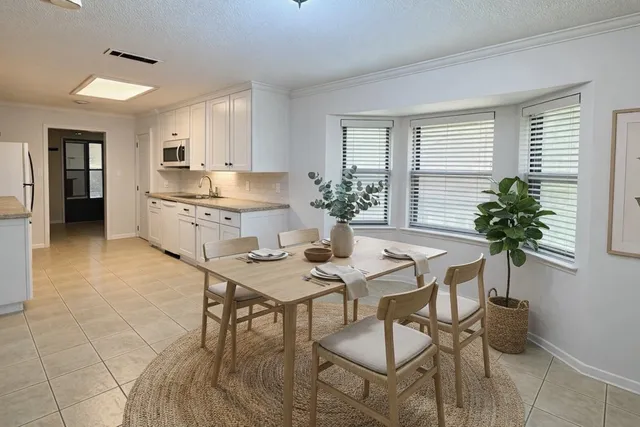 a view of a livingroom with a chandelier a kitchen sink and dishwasher