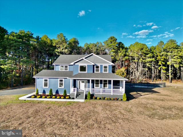 a front view of a house with a yard and balcony