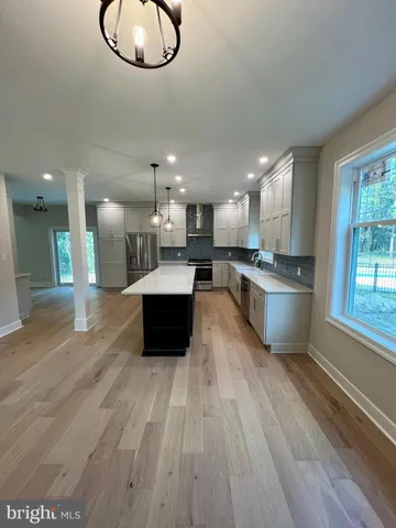 a bathroom with a granite countertop bathtub shower sink vanity and toilet