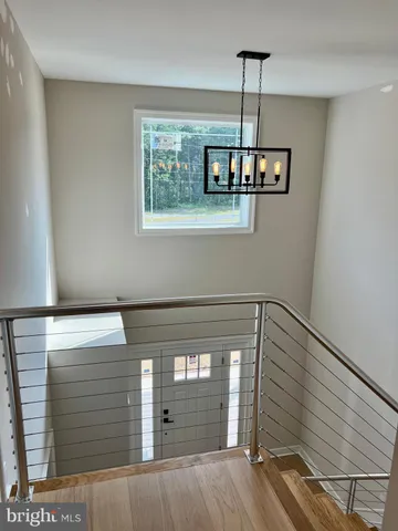a view of a room with a wooden floor and a window
