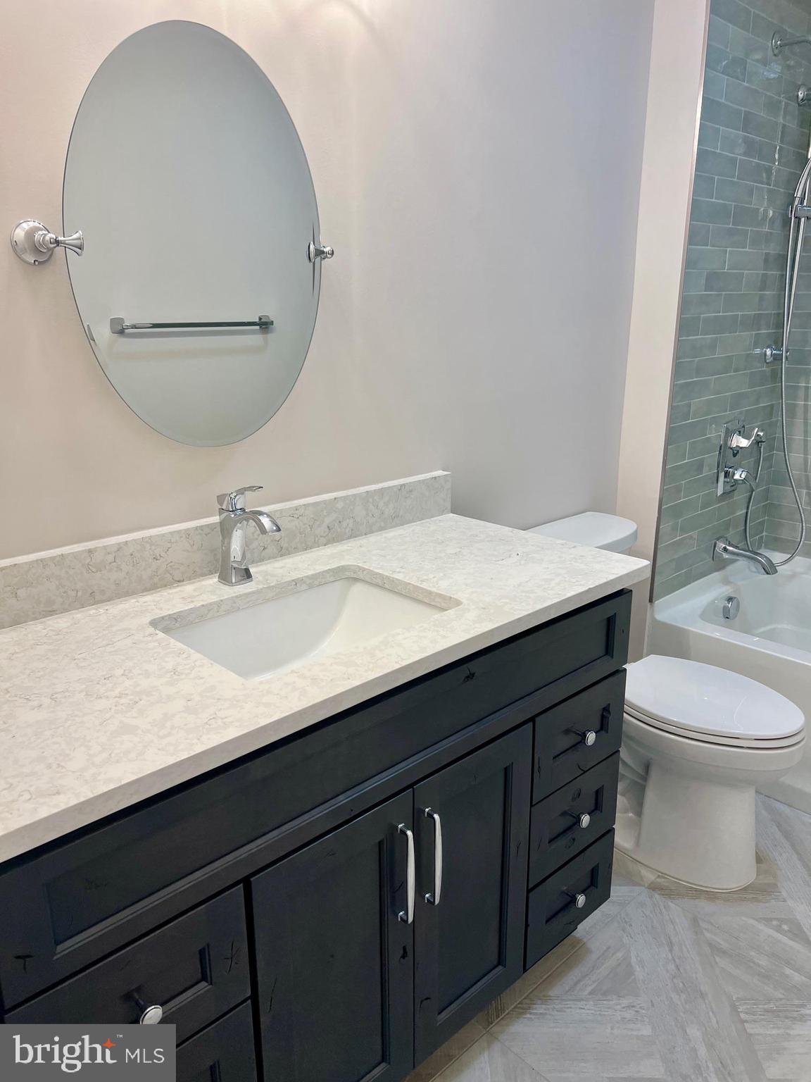 11 2nd Street Chatsworth, NJ 08019 - Photo 28 of 85 a bathroom with a granite countertop sink a toilet and a mirror