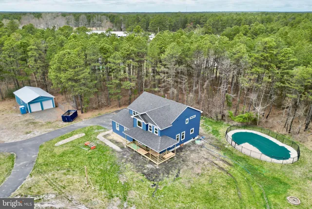 an aerial view of a house with a yard basket ball court and outdoor seating