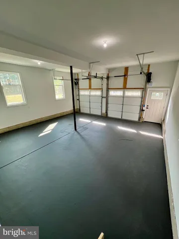 a view of a backyard with plants and lake view