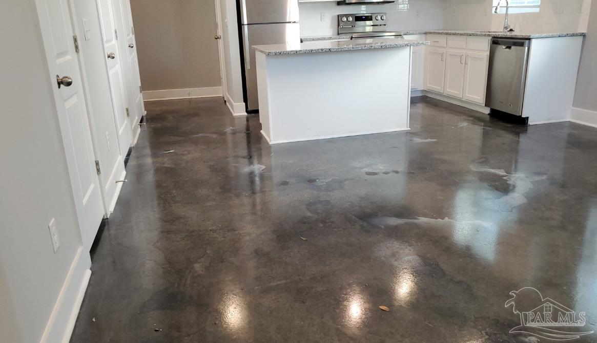 9822 Utopia Drive, Unit E Pensacola, FL 32514 - Photo 13 of 13 a view of a refrigerator in kitchen and an empty room